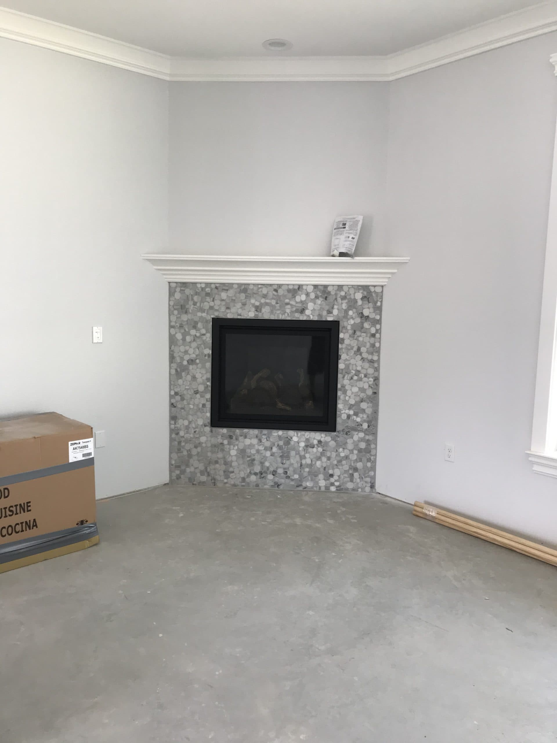 Fireplace mantel installation with tile and millwork Sacramento