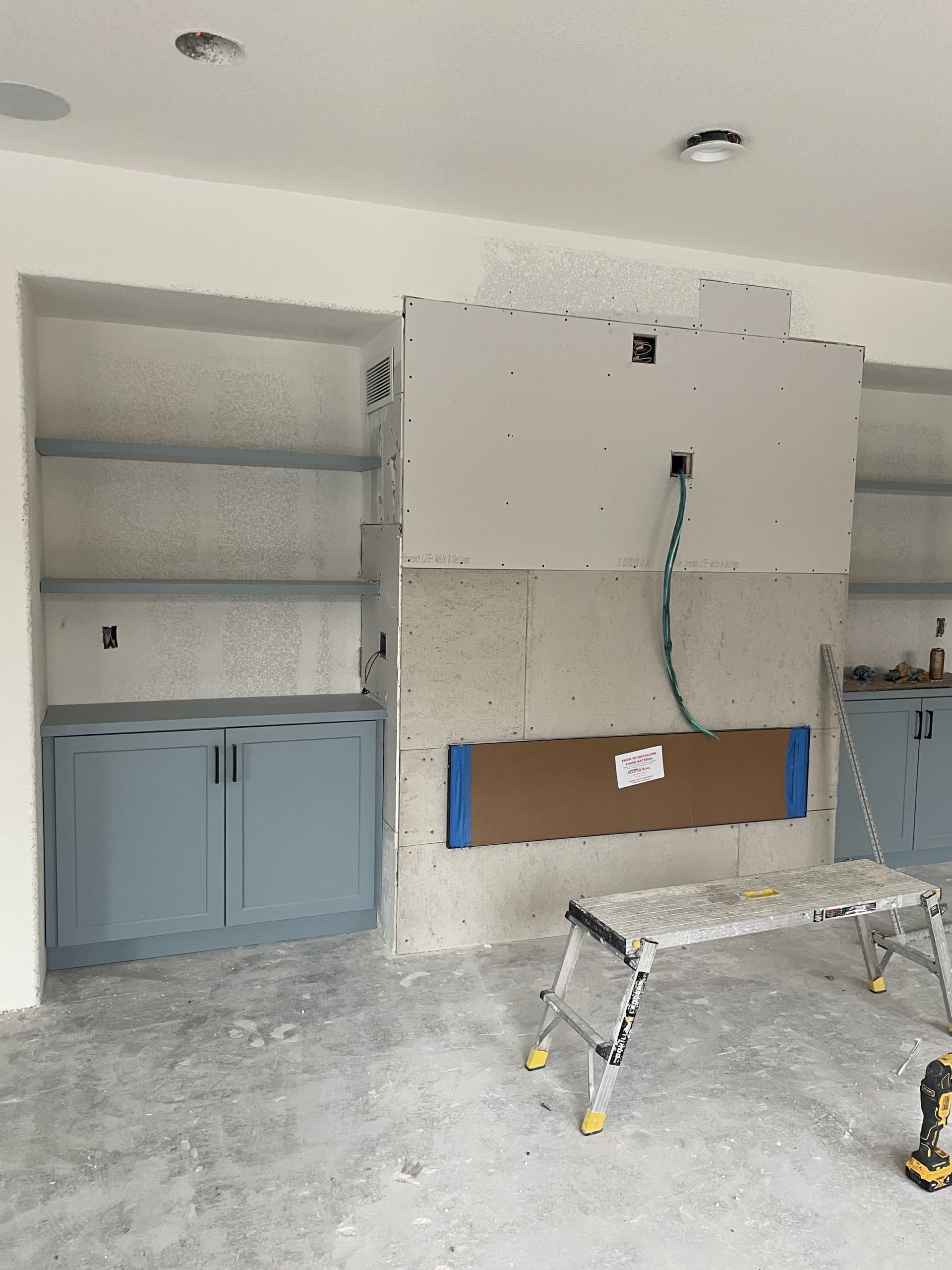 Fireplace renovation with marble tile and shelving Sacramento