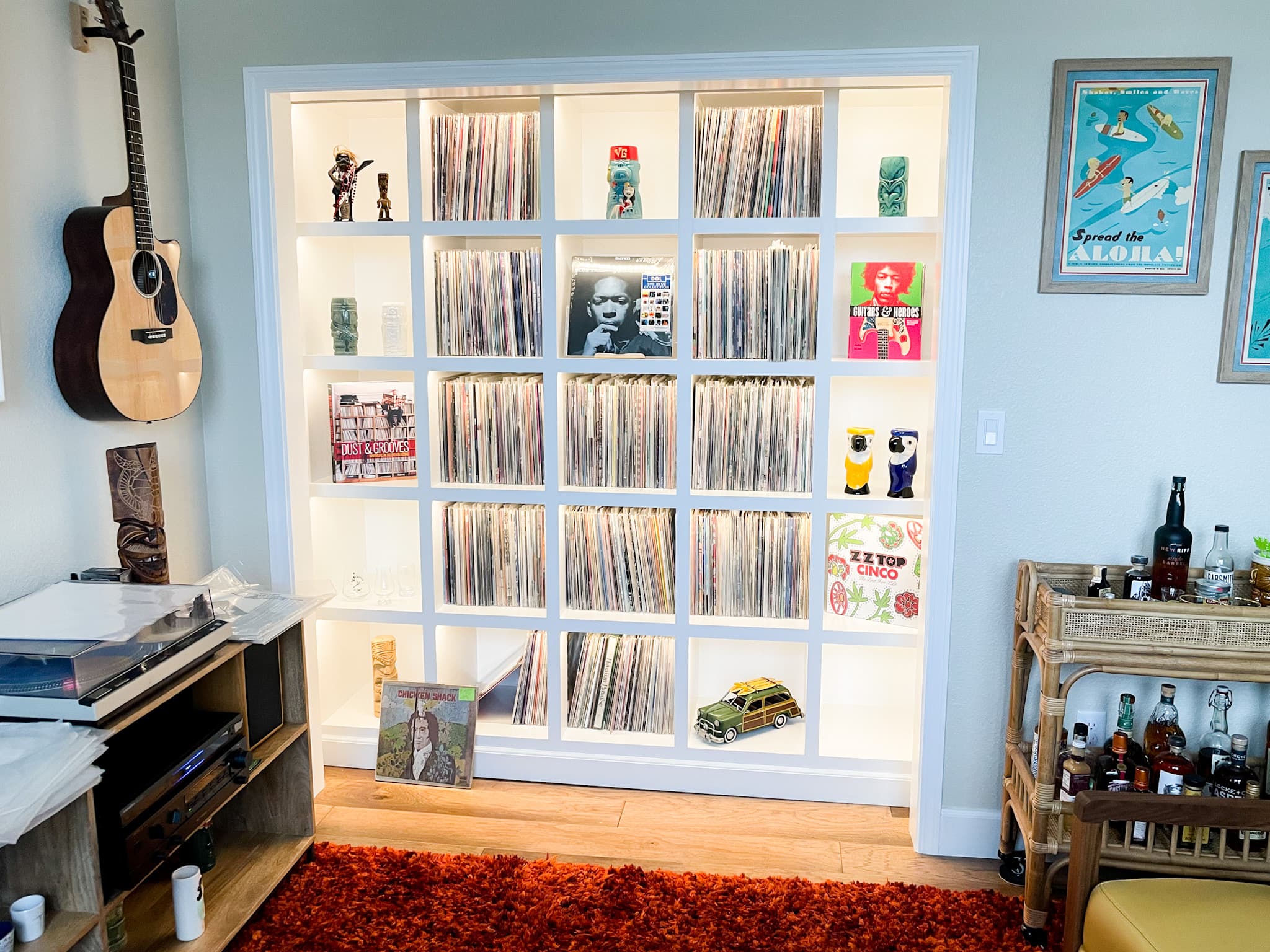Custom built-in shelving unit with LED backlighting displaying a vinyl record collection