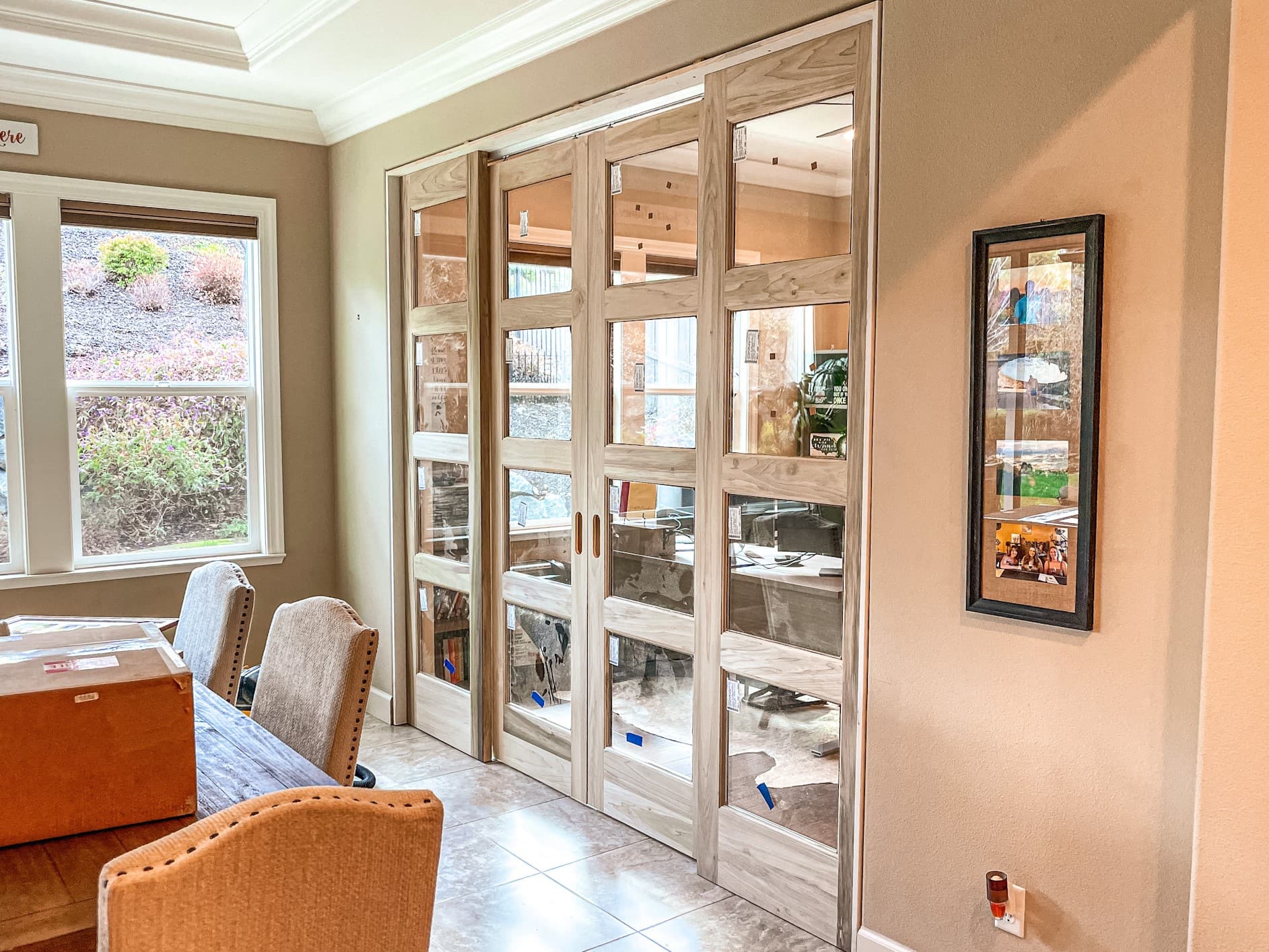 Custom glass bi-fold doors opening to an outdoor living space