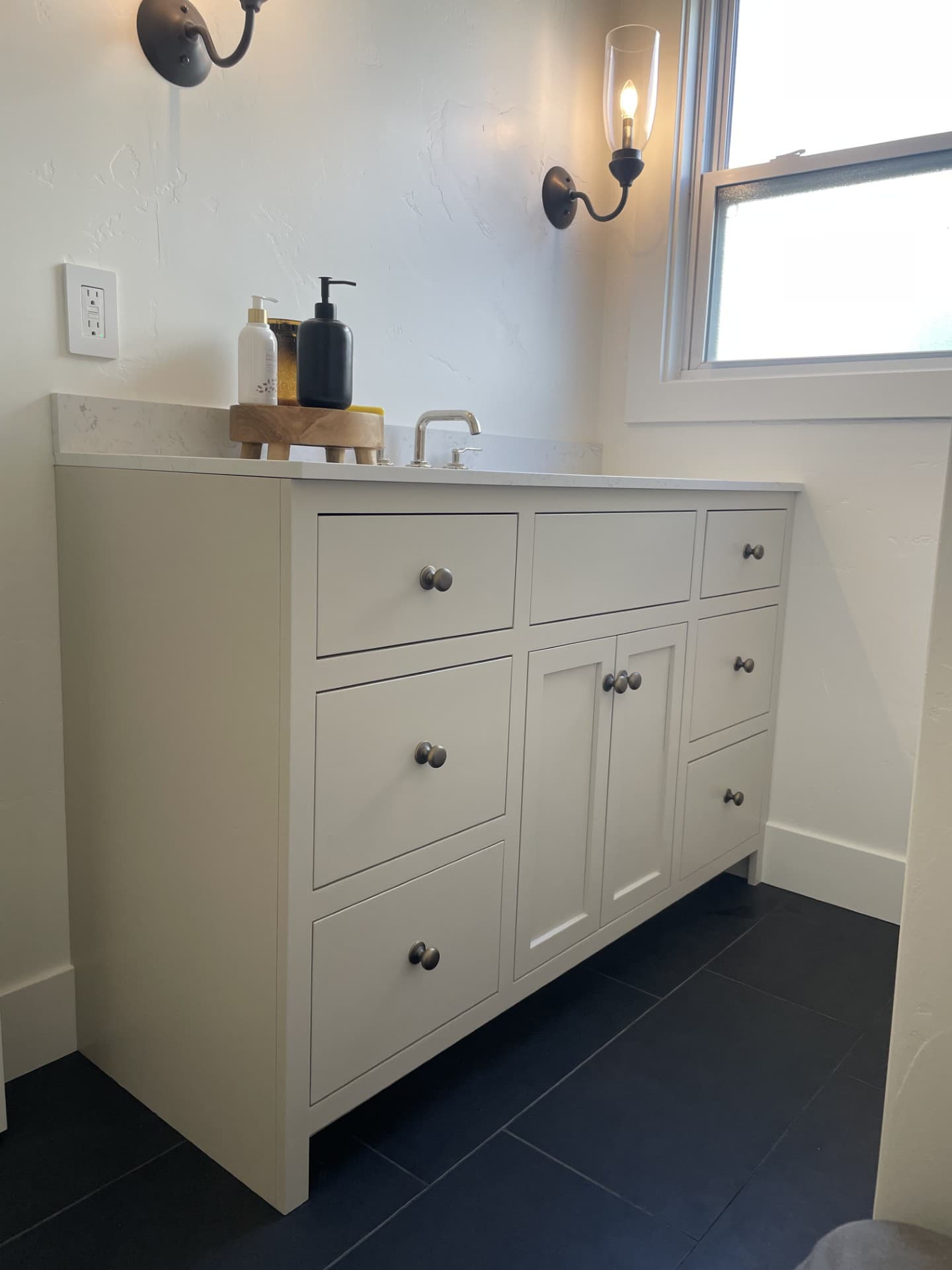 Completed bathroom with white shaker vanity and brass hardware Carmichael